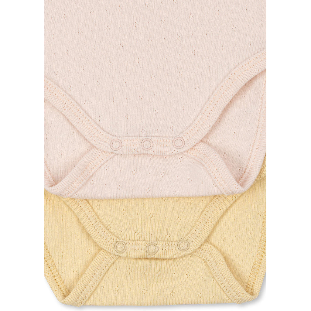 Fanga Fontana Perla bodystocking med lange ermer, 2-pak – Banana crepe/creole pink – str. 0–9 mnd.